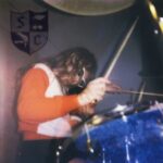 Album cover, Snocaps, Snocaps. Features a woman playing a drum kit.